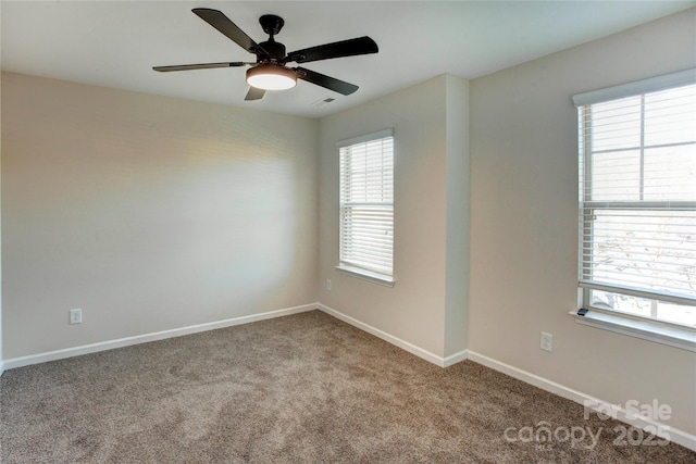 carpeted spare room featuring ceiling fan