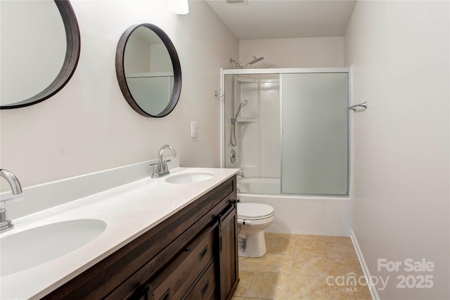 full bathroom featuring tile patterned floors, toilet, combined bath / shower with glass door, and vanity