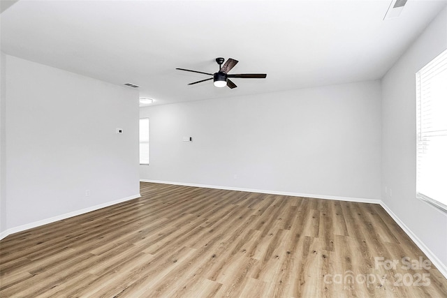 empty room with ceiling fan and light wood-type flooring