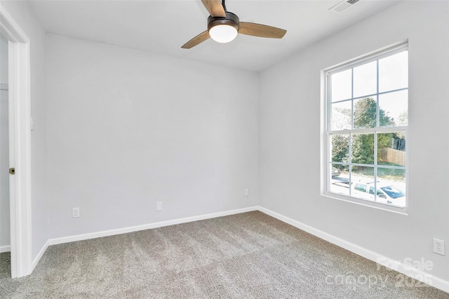 carpeted spare room featuring ceiling fan