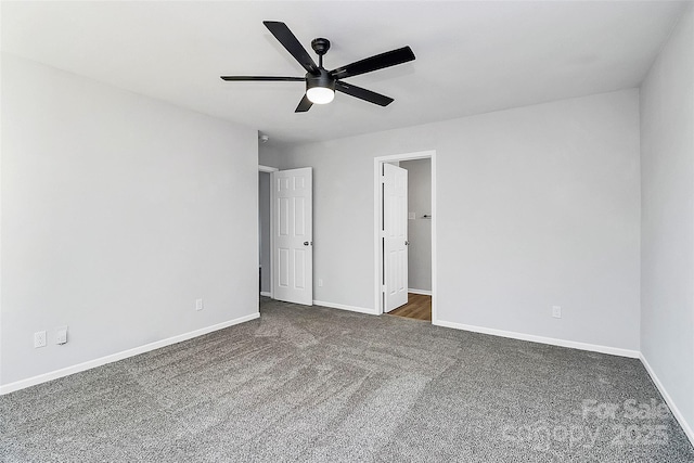 unfurnished bedroom featuring ceiling fan and dark carpet