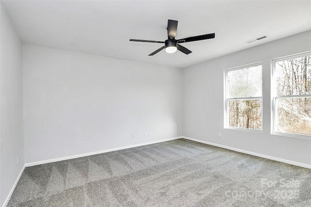 spare room with ceiling fan and carpet