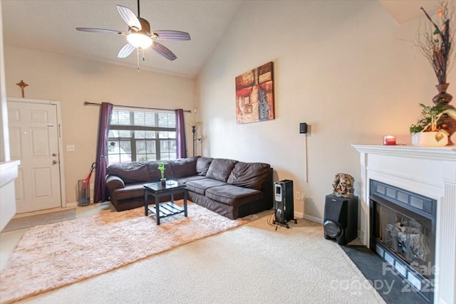 carpeted living room with ceiling fan and high vaulted ceiling