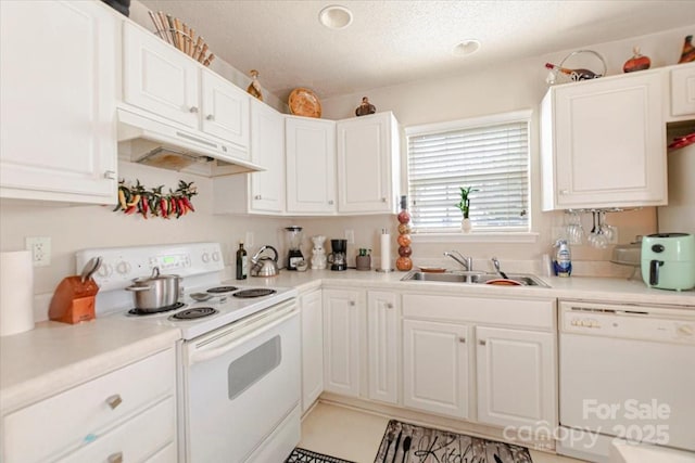 kitchen featuring a textured ceiling, white appliances, white cabinetry, and sink