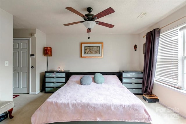 carpeted bedroom with a closet and ceiling fan