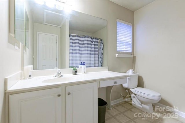 bathroom featuring walk in shower, vanity, and toilet