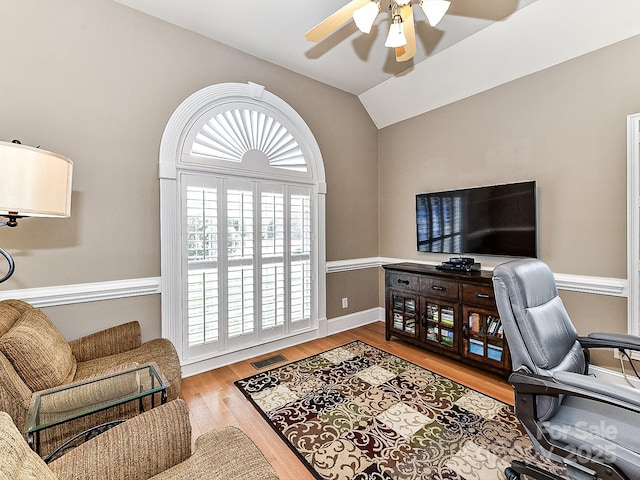 office area featuring ceiling fan, vaulted ceiling, and light wood-type flooring