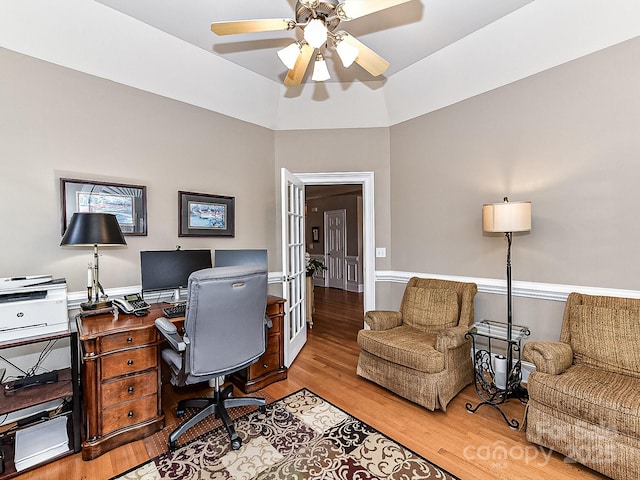 home office featuring ceiling fan, light hardwood / wood-style floors, french doors, and vaulted ceiling