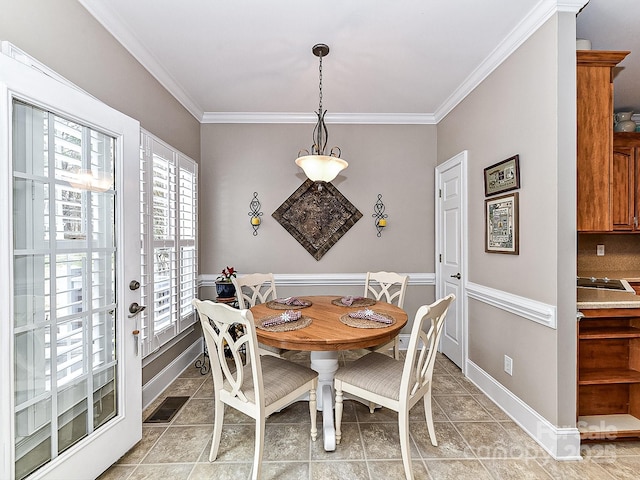 dining room featuring light tile patterned floors and ornamental molding