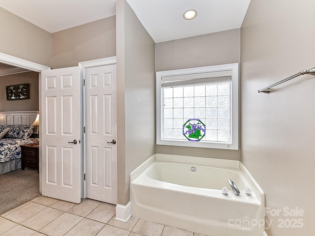 bathroom featuring a tub to relax in and tile patterned floors