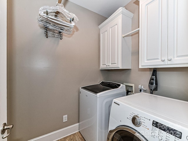 laundry room with cabinets and washing machine and clothes dryer