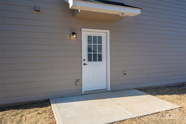 property entrance featuring a patio area