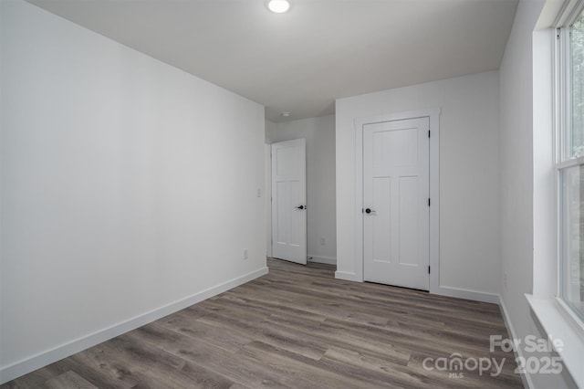 unfurnished bedroom with hardwood / wood-style floors