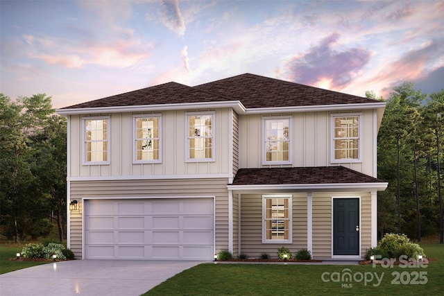 view of front of house featuring a garage and a yard