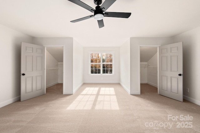 additional living space with ceiling fan and light colored carpet