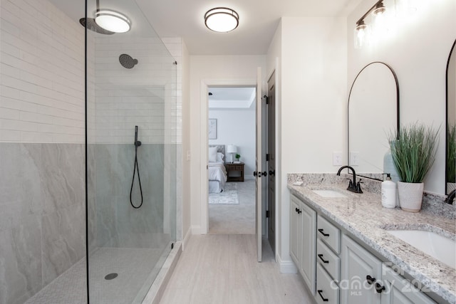 bathroom with vanity and tiled shower