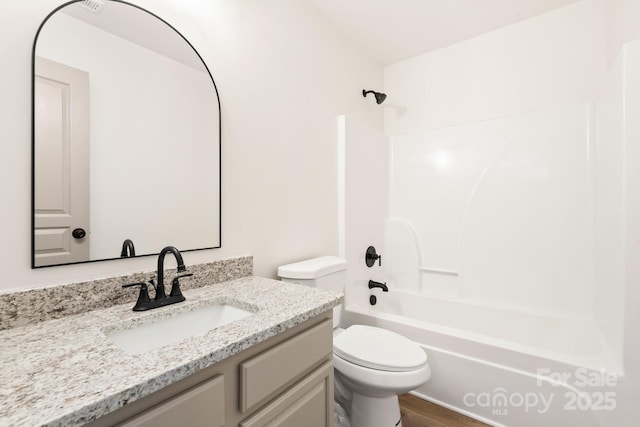 full bathroom with hardwood / wood-style floors, vanity, toilet, and bathing tub / shower combination