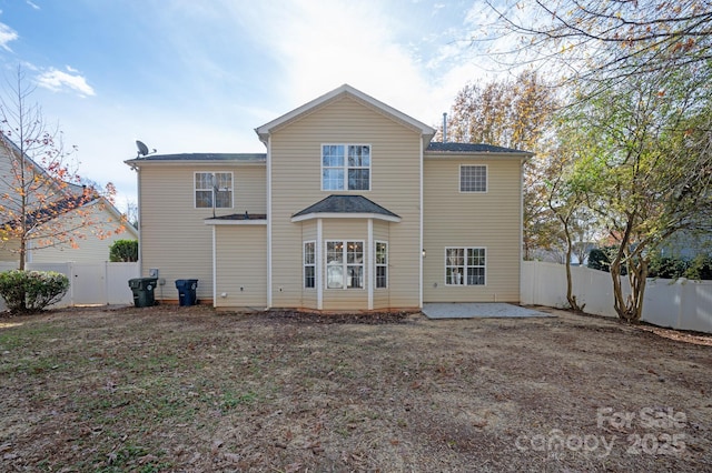 back of property with a patio