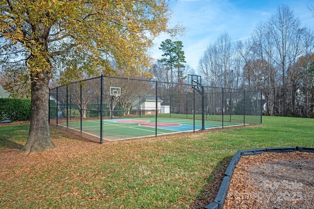 view of basketball court with a lawn