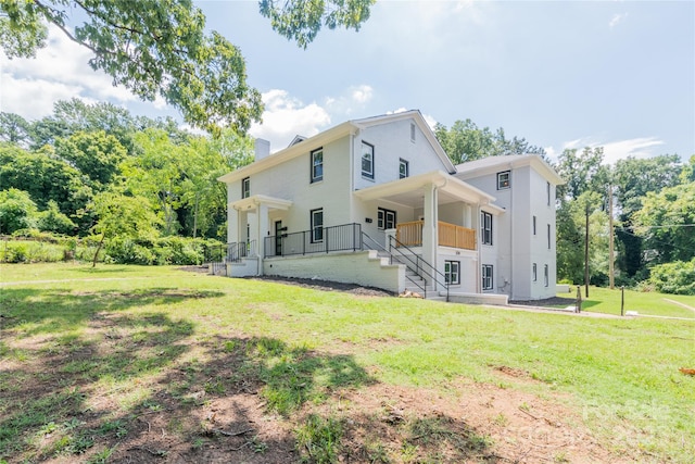 rear view of property with a yard