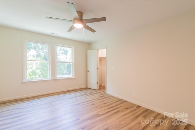 unfurnished room with ceiling fan and light wood-type flooring