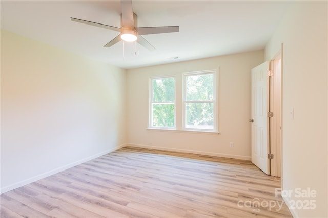 empty room featuring light wood-type flooring and ceiling fan