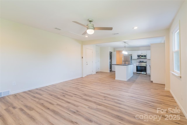 unfurnished living room with ceiling fan and light hardwood / wood-style flooring