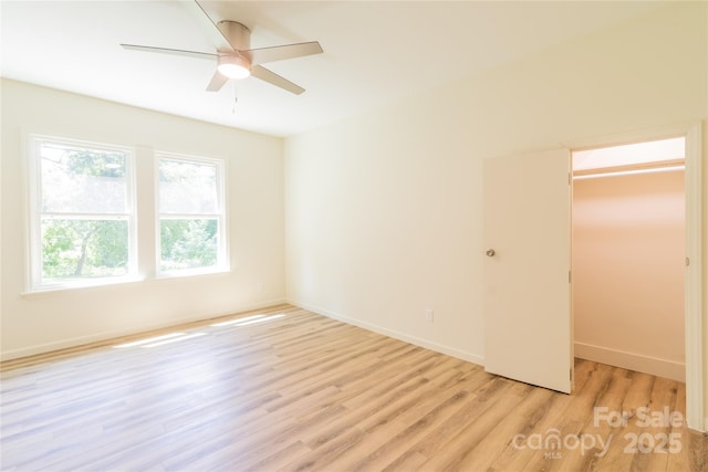 empty room featuring ceiling fan and light hardwood / wood-style flooring