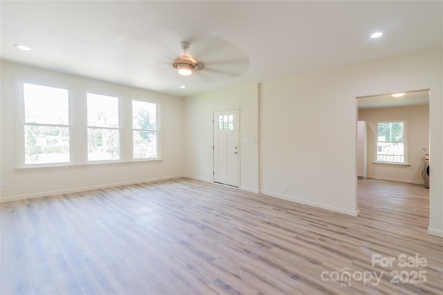 spare room with ceiling fan and light wood-type flooring