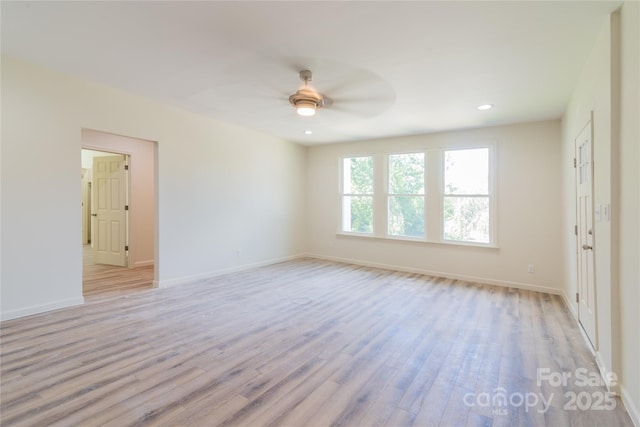 unfurnished room featuring ceiling fan and light wood-type flooring