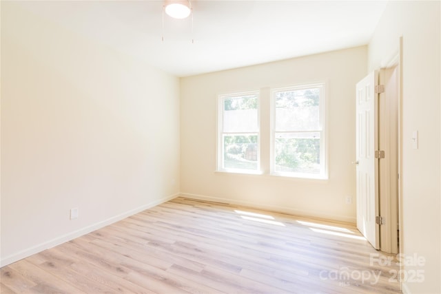 unfurnished room with light wood-type flooring