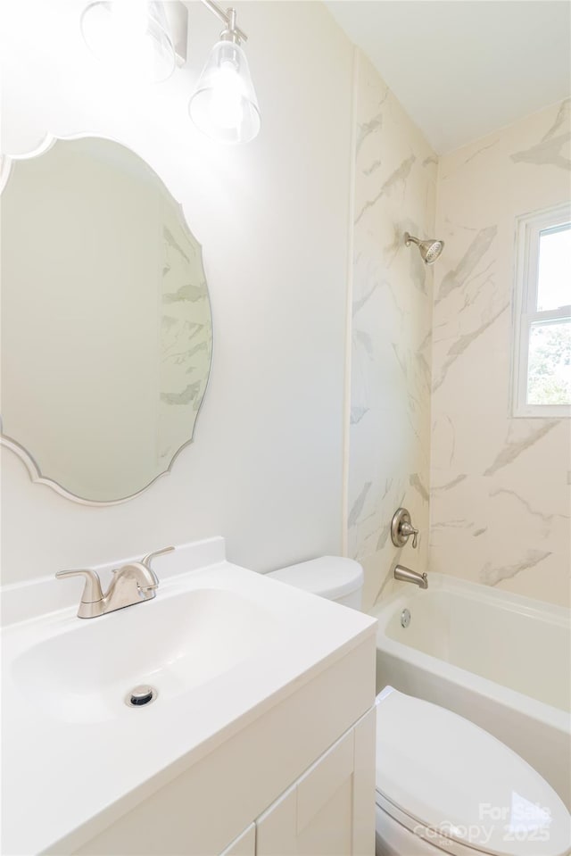 full bathroom with vanity, toilet, and tiled shower / bath