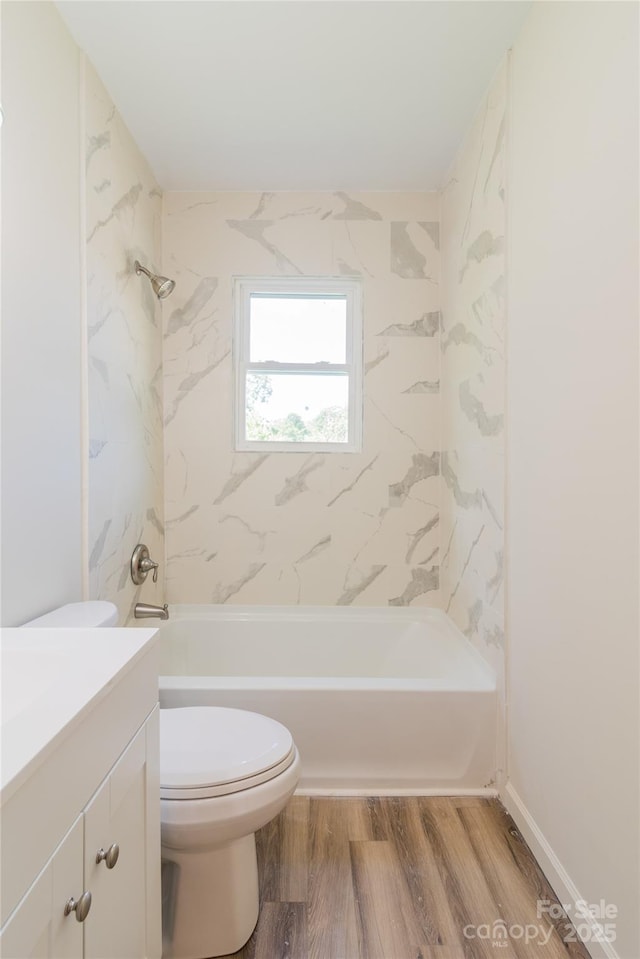 full bathroom featuring wood-type flooring, vanity, toilet, and tiled shower / bath