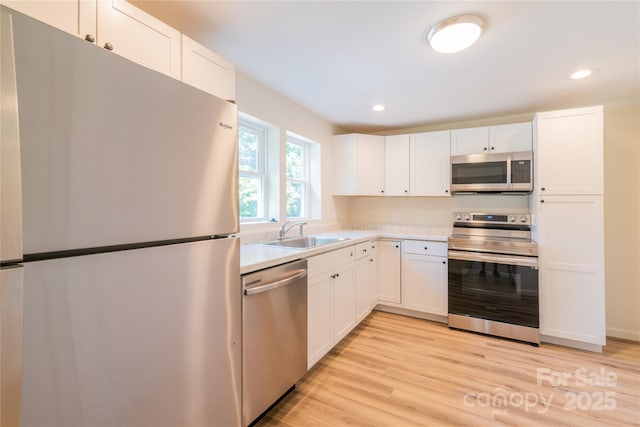 kitchen with white cabinets, sink, and stainless steel appliances