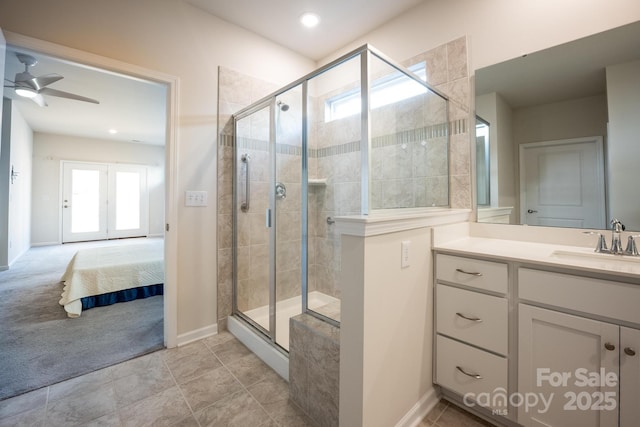 bathroom featuring ceiling fan, vanity, and a shower with shower door