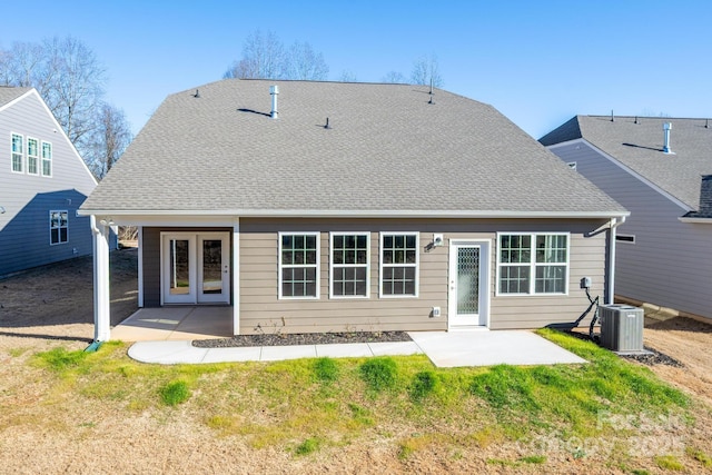 back of property with a patio and central AC