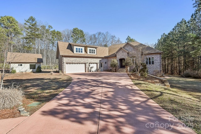 view of front of house with a garage and a front yard