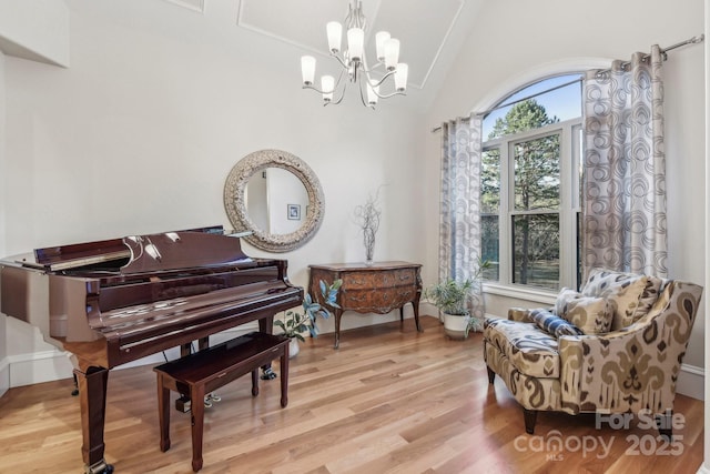 sitting room with light wood-type flooring and a notable chandelier