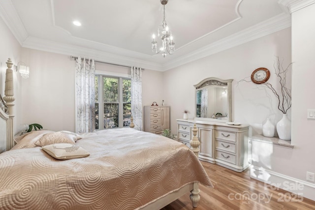 bedroom featuring light hardwood / wood-style floors, crown molding, and an inviting chandelier