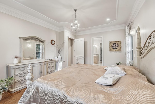 bedroom featuring wood-type flooring, ornamental molding, and a chandelier