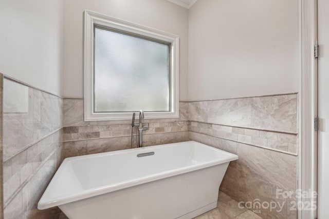 bathroom featuring tile walls and a bathing tub