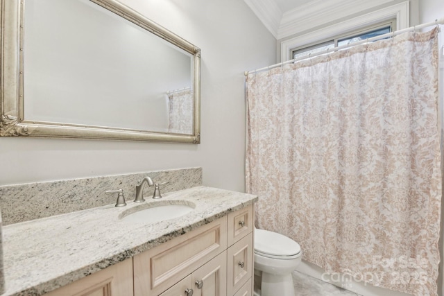 bathroom featuring vanity, toilet, and ornamental molding