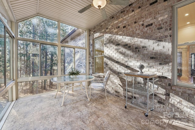 unfurnished sunroom featuring ceiling fan, wooden ceiling, and vaulted ceiling