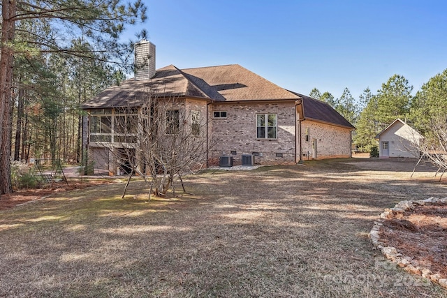 back of house featuring central AC and a sunroom