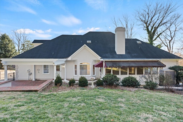 back of property with a patio area and a yard