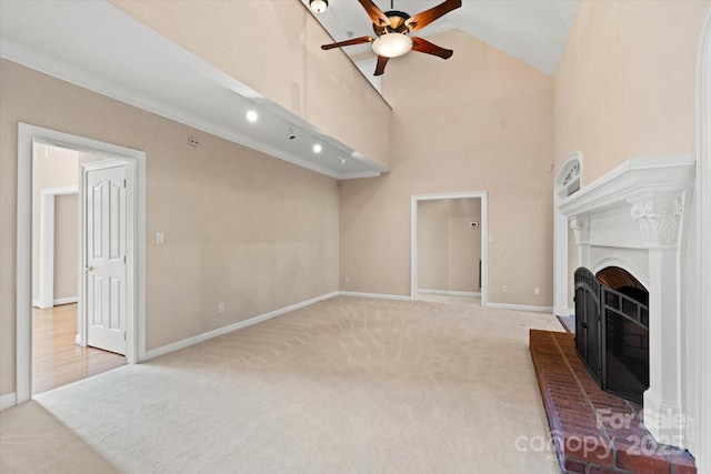 living room with light carpet, a brick fireplace, ornamental molding, and ceiling fan