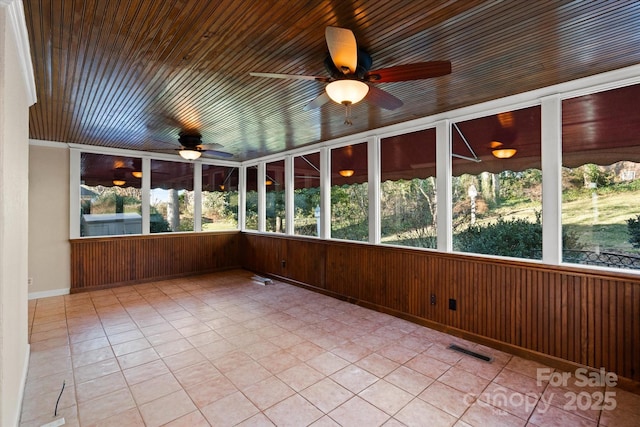 unfurnished sunroom with ceiling fan and a wealth of natural light