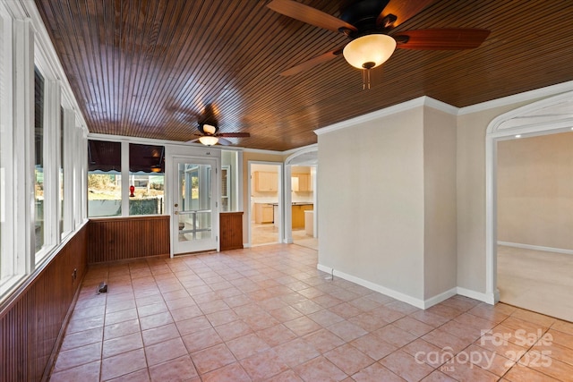 unfurnished sunroom with ceiling fan and wood ceiling