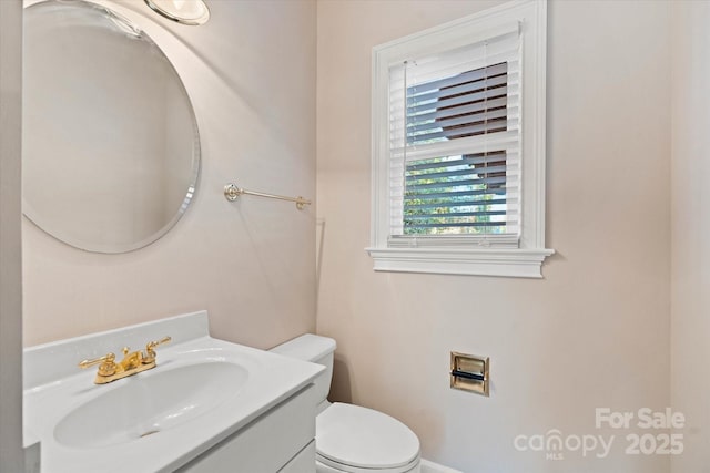 bathroom featuring toilet and vanity