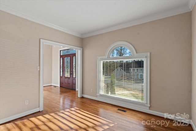 entrance foyer featuring light wood-type flooring, french doors, and ornamental molding